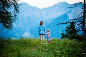 Mother and daughter walking in moutains