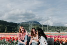 Friends laughing together in tulip field