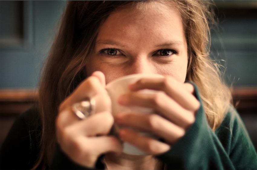 girl with ring and mug smiling